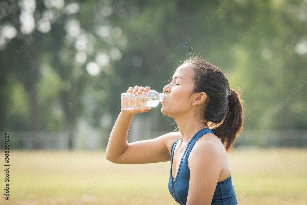 beautiful young woman drinking water after training beautiful young woman drinking water after training