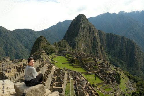 Brunette looking over shoulder at Machu Picchu