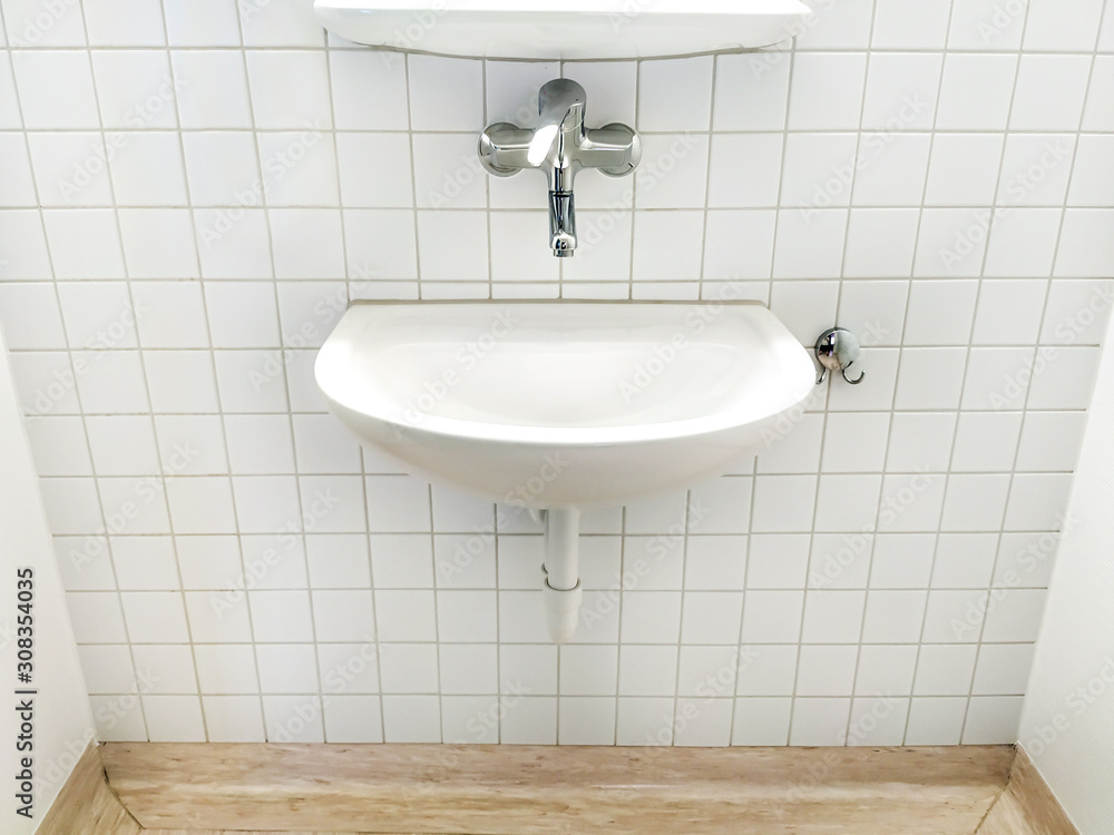 Fototapeta premium one white sink and faucet in public toilet