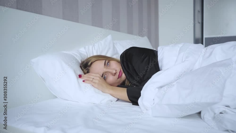 Charming young woman woke up in bed in the bedroom in the morning pillow adult attractive stretch beautiful female happy relax relaxation wake sleep lying slow motion Charming young woman woke up in bed in the bedroom in the morning pillow adult attractive stretch beautiful female happy relax relaxation wake sleep lying slow motion