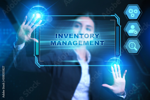 Business, Technology, Internet and network concept. Businessman presses a button Inventory management on the virtual screen tablet future.