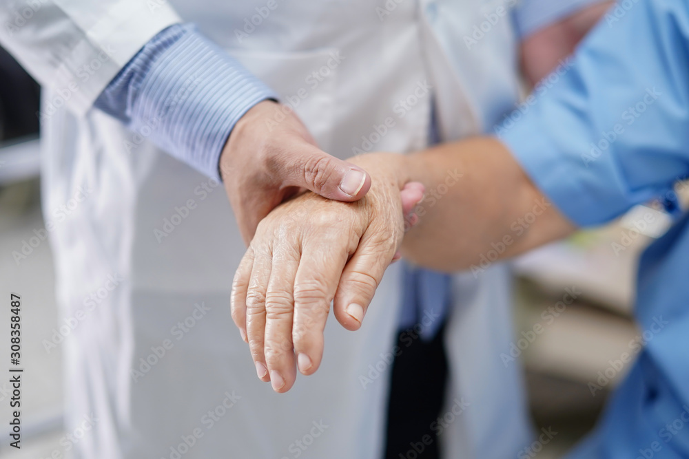 Holding Touching hands Asian senior or elderly old lady woman patient with love, care, helping, encourage and empathy at nursing hospital ward : healthy strong medical concept . Holding Touching hands Asian senior or elderly old lady woman patient with love, care, helping, encourage and empathy at nursing hospital ward : healthy strong medical concept .