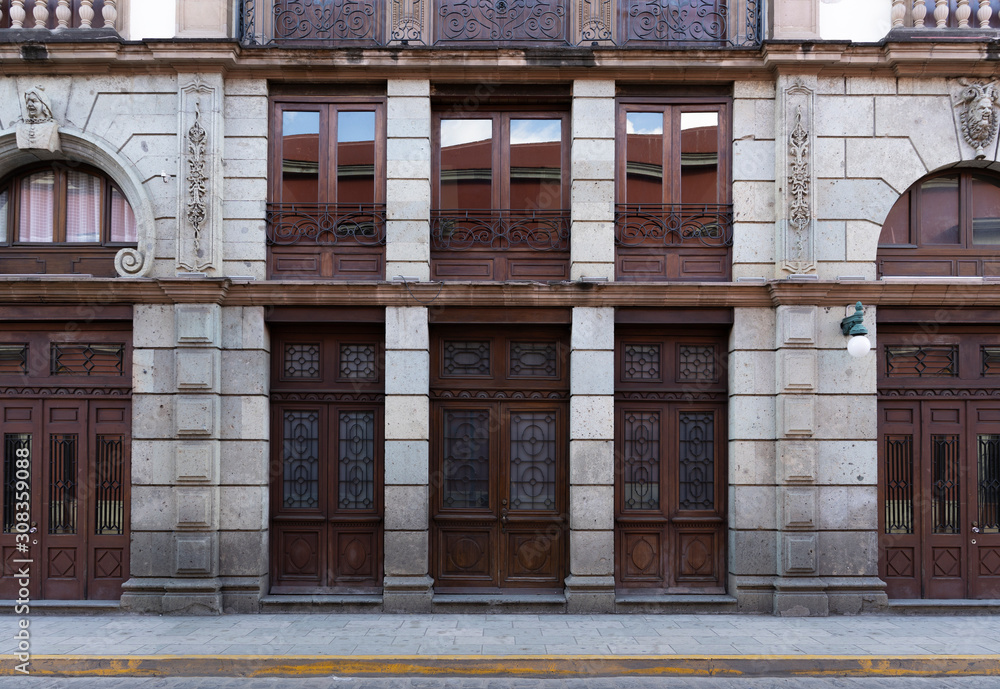 stone facade and dark wood windows