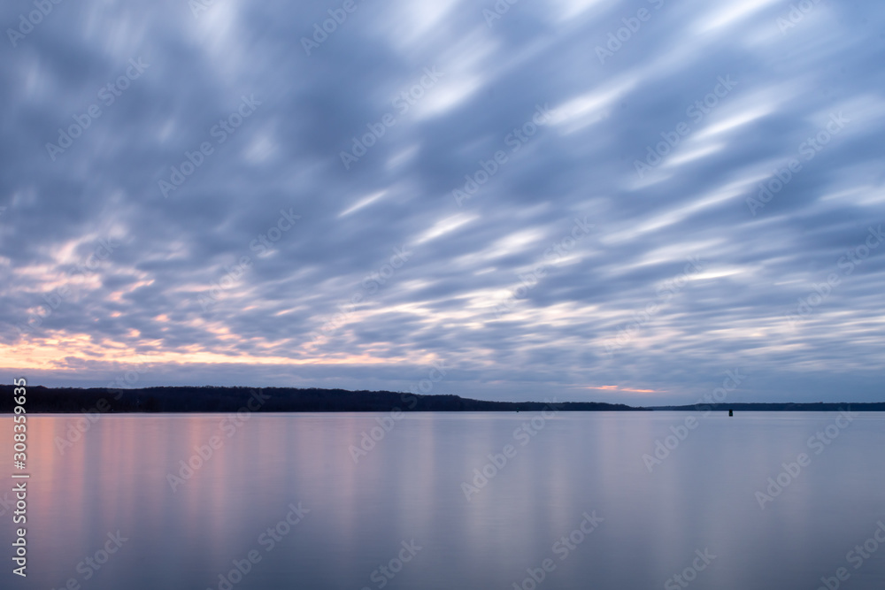 Sky with Clouds and Calm River Water at Dusk