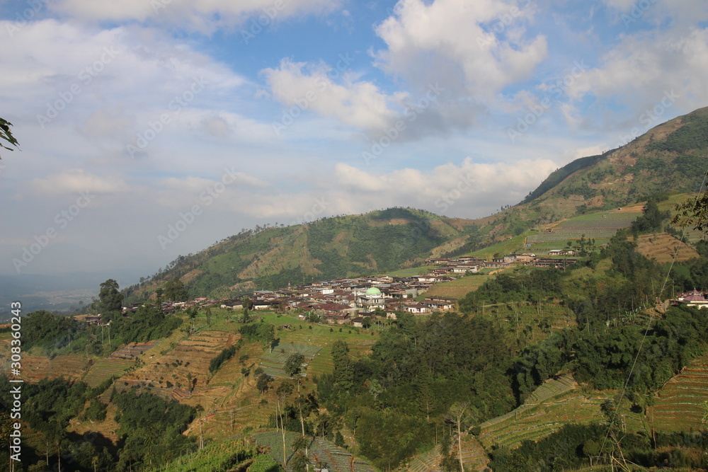 agriculture on the slopes of the mountains under the blue sky