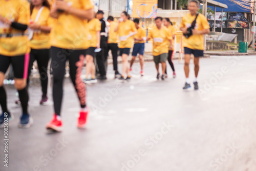 Out of focus and blurry background of marathon running race at the city road in the morning time.Family outdoor exercise for healthy.
