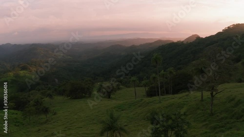 Beautiful aerial drone shot of beautiful nature at sunset at Monteverde National Park / Cloud Forest in Costa Rica. The jungle rain forest an important source of fresh water and clean air. photo