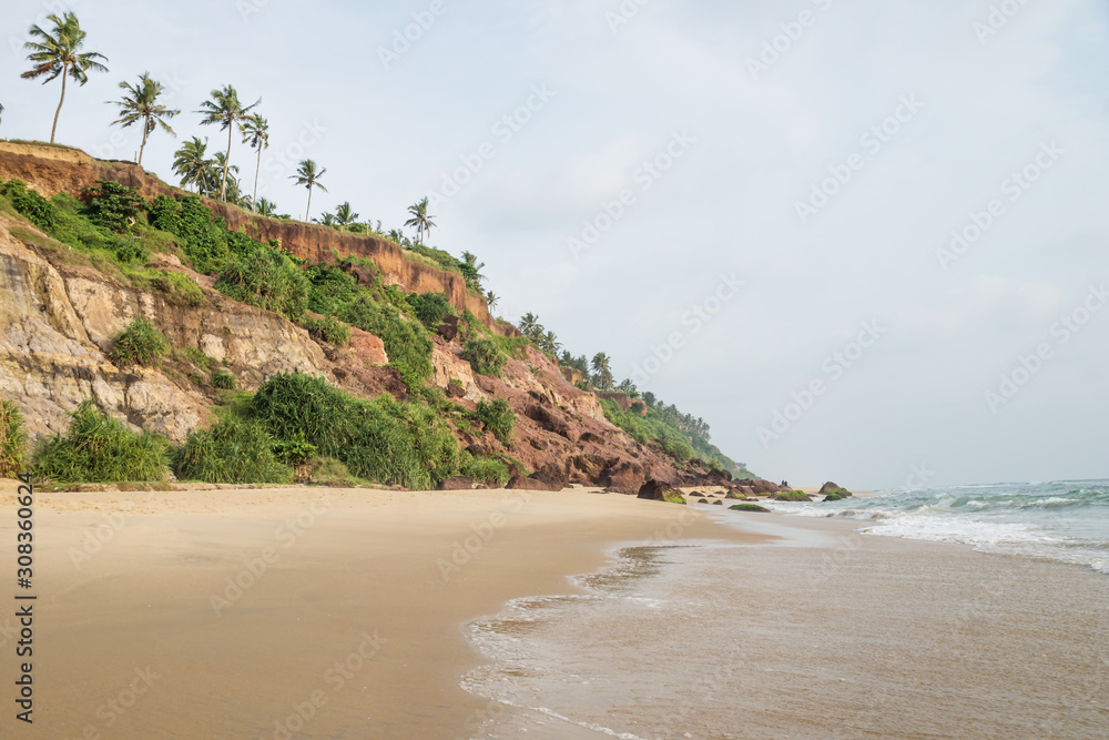 Water at the cliff of Varkala along the coast with volcanic stones, India