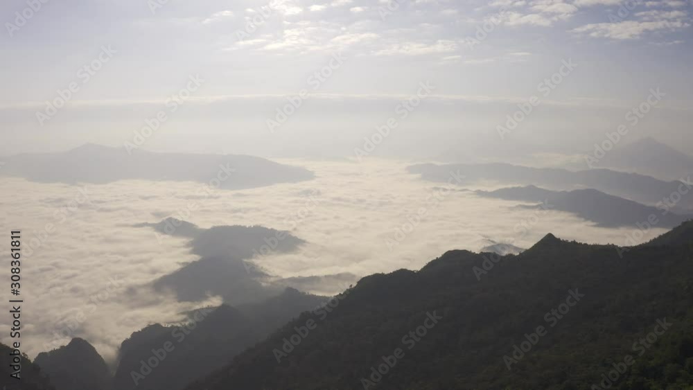 Aerial view Drone flying over a beautiful green mountain forest. Tourist destination on a hilltop during the foggy and beautiful light in the morning and sunset in Chiang Rai Thailand. Footage B roll. Aerial view Drone flying over a beautiful green mountain forest. Tourist destination on a hilltop during the foggy and beautiful light in the morning and sunset in Chiang Rai Thailand. Footage B roll.