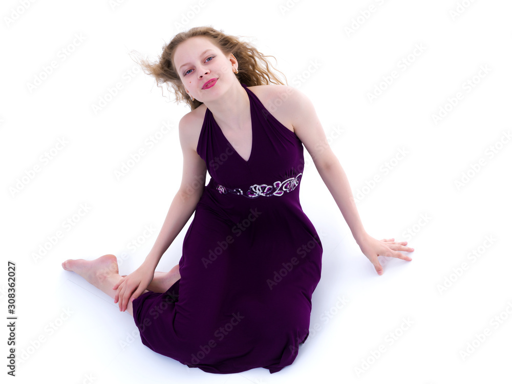Naklejka premium Teen girl posing on the floor in the studio. The concept of styl