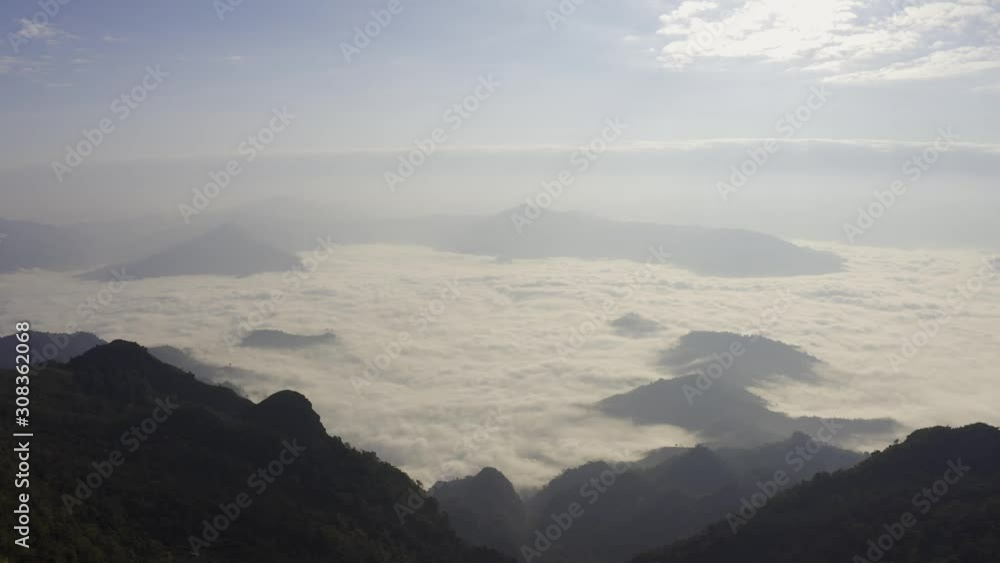 Aerial view Drone flying over a beautiful green mountain forest. Tourist destination on a hilltop during the foggy and beautiful light in the morning and sunset in Chiang Rai Thailand. Footage B roll. Aerial view Drone flying over a beautiful green mountain forest. Tourist destination on a hilltop during the foggy and beautiful light in the morning and sunset in Chiang Rai Thailand. Footage B roll.