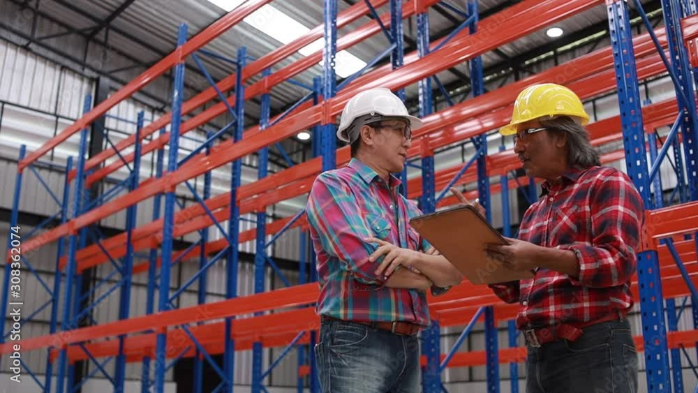 Asian engineer and worker working in factory 