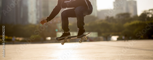 Photography Skateboarder skateboarding at sunset city