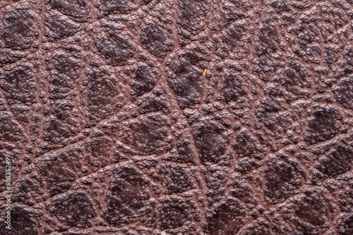 Brown leather fabric close up macro background.