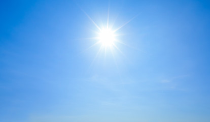 Shining sun with rays and clear blue sky