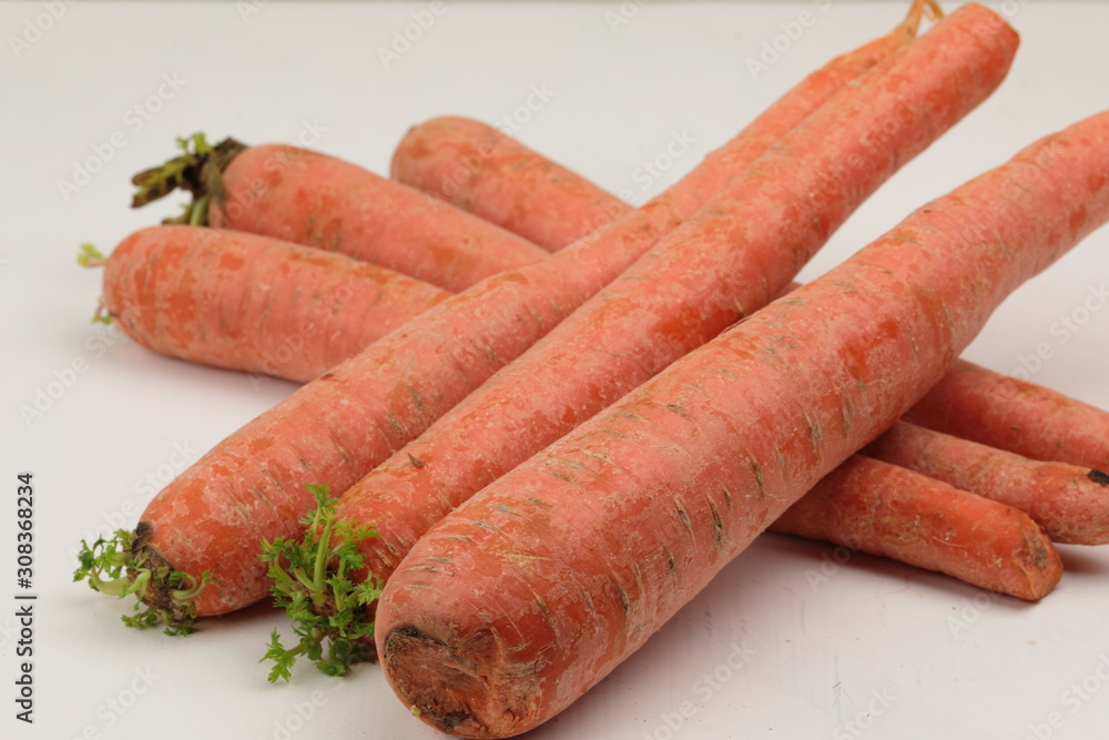 A stack of orange Carrots on a wooden background