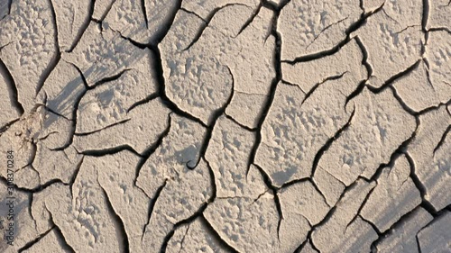 Looking down at the cracked surface of a dry river