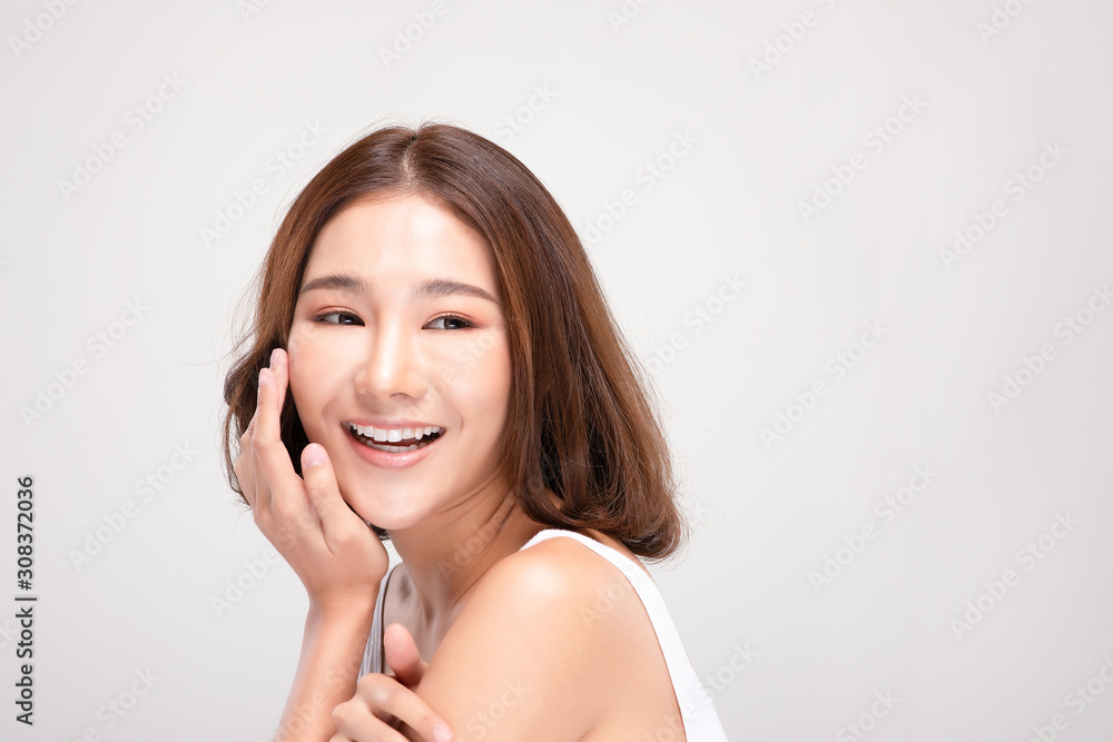 Beautiful Asian young woman touching soft cheek smile with clean and fresh skin Happiness and cheerful with positive emotional,isolated on gray background,Beauty and Cosmetics Concept Beautiful Asian young woman touching soft cheek smile with clean and fresh skin Happiness and cheerful with positive emotional,isolated on gray background,Beauty and Cosmetics Concept