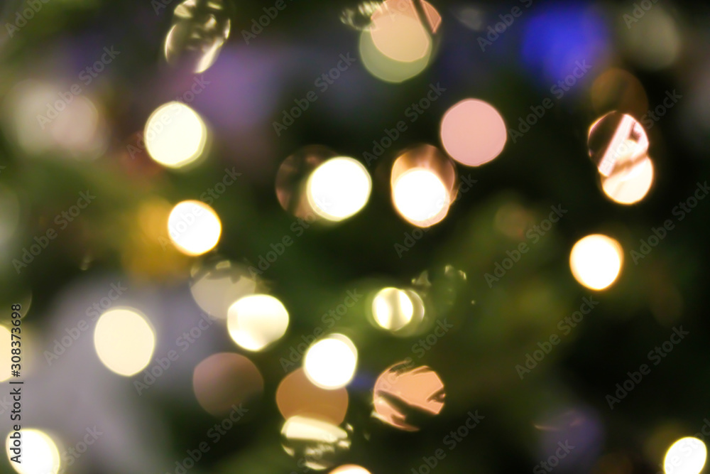 Christmas abstract blurred background with bokeh colorful circles. Artificial fir tree with led light garland. Festive holiday background. Christmas abstract blurred background with bokeh colorful circles. Artificial fir tree with led light garland. Festive holiday background.
