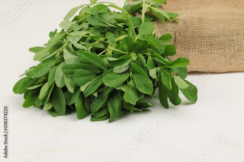 Fenugreek leavs or Methi leaves in a burlap bag