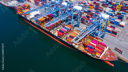 Aerial view container ship at industrial port in import export business logistic and transportation of international by container ship in the open sea.