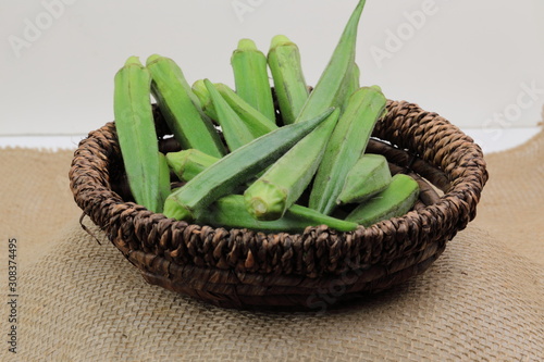 A bundle of fresh Lady's finger or Okra on wooden background with copy space.