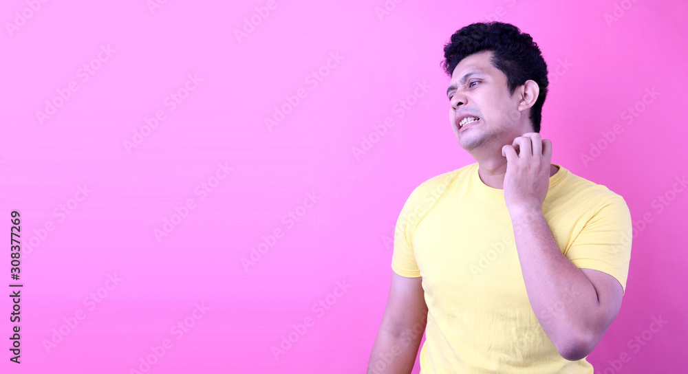 Portrait of Asia man scratching neck and Annoying itch on pink background in studio With copy space. Portrait of Asia man scratching neck and Annoying itch on pink background in studio With copy space.