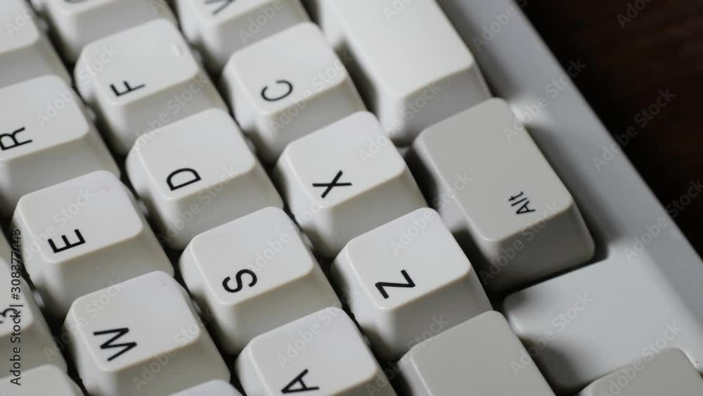 Finger presses Z button on keyboard Finger presses Z button on keyboard