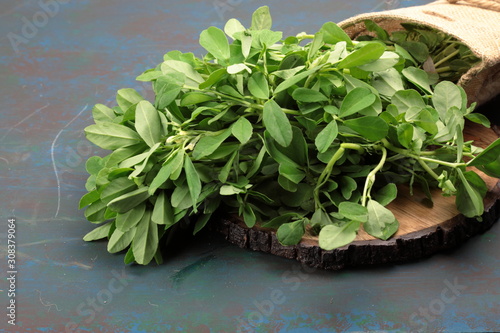 Fenugreek leavs or Methi leaves in a burlap bag photo