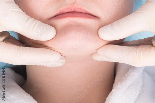 close-up of hands doing facial massage to young woman, skin care