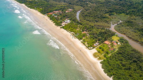 Close up aerial view of a Green Coast beach with turquoise water, meandering river and forest, Brazil photo