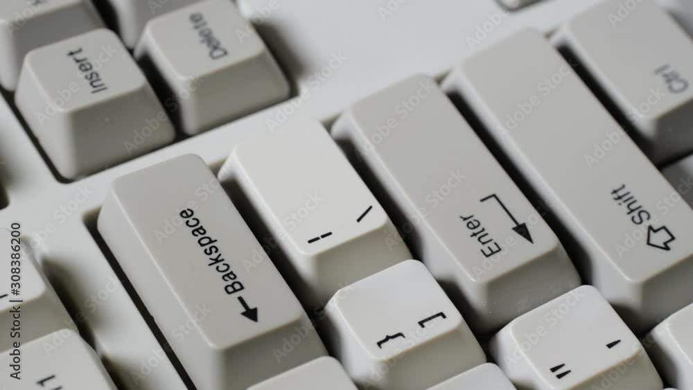 Finger presses BACKSPACE button on keyboard Finger presses BACKSPACE button on keyboard