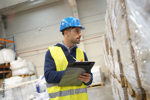 Warehouseman controlling incoming goods photo