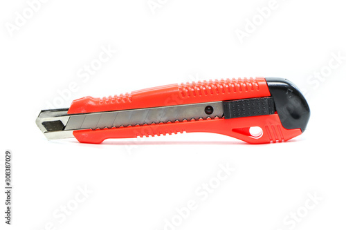 Red cutter knife. The blade is open, isolated on white background.