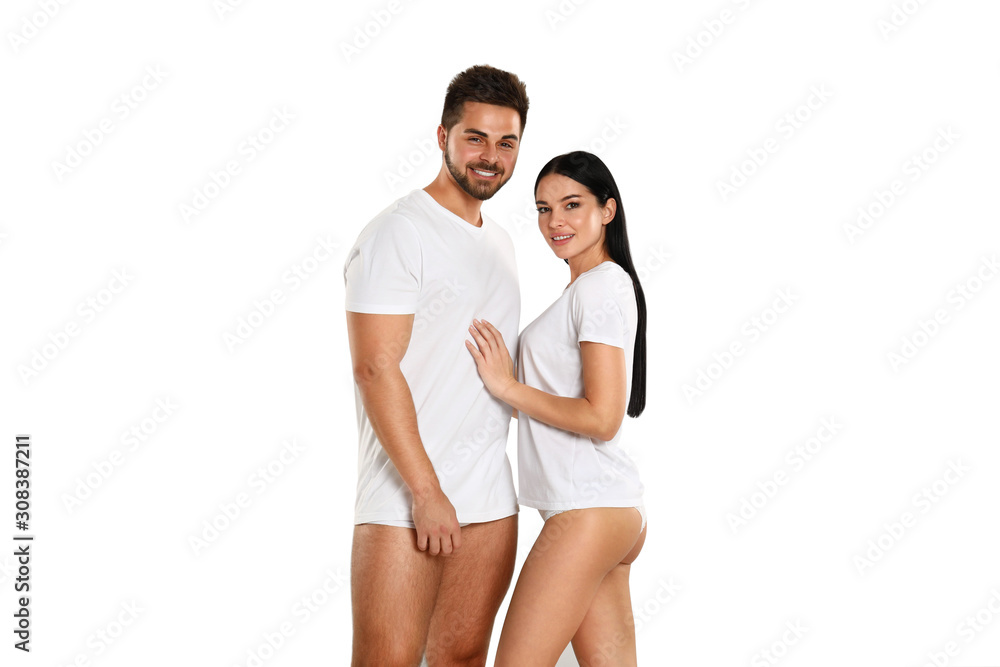 Young couple in white t-shirts and underwear on light background Young couple in white t-shirts and underwear on light background