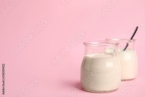 Tasty organic yogurt on pink background. Space for text