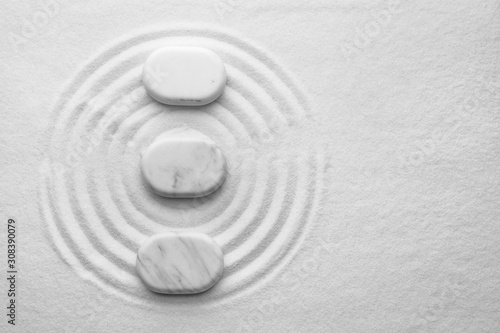 Photography White stones on sand with pattern, flat lay