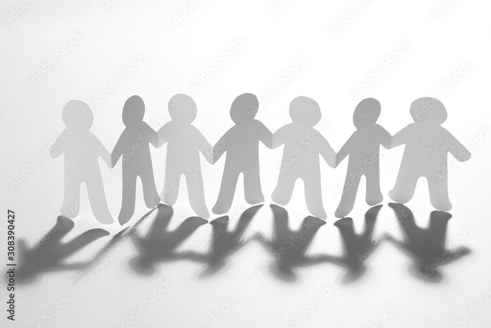 Paper people holding hands on white background. Unity concept Paper people holding hands on white background. Unity concept