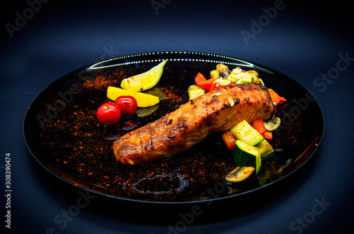 Salmon under teriyaki sauce on black background photo