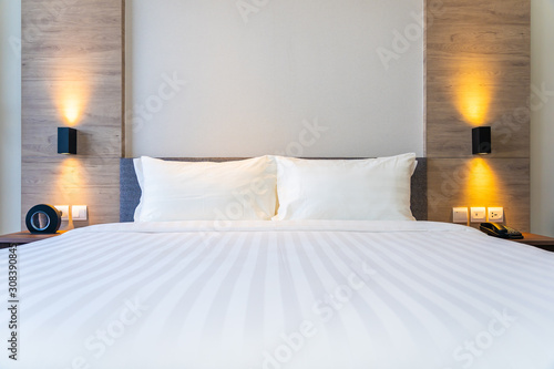 White comfortable pillow on bed decoration interior photo