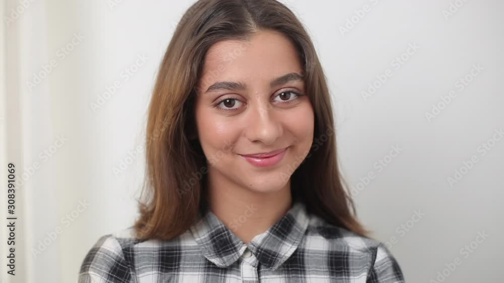 Portrait of a young Indian female student on a white background. Beautiful smiling brunette girl. Portrait of a young Indian female student on a white background. Beautiful smiling brunette girl.