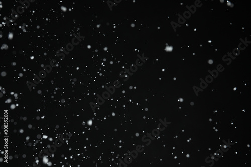 White snow falling down on black background © New Africa