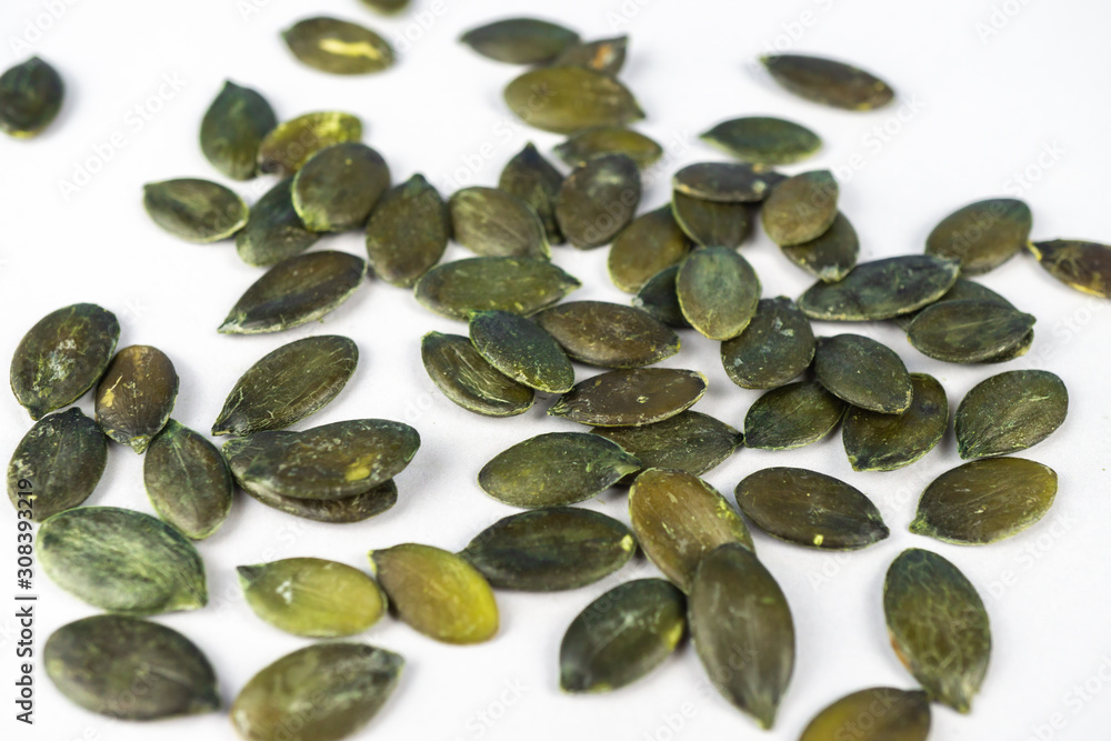 Pumpkin seeds on white background with copy space Pumpkin seeds on white background with copy space