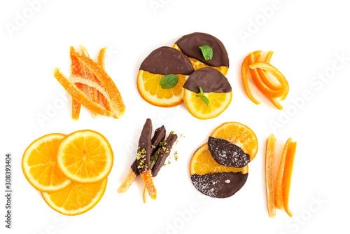 Set of homemade candied oranges and orange peel some pieces dipped in chocolate or salt and fresh mint. Candied orange peel in chocolate or sugar is a favorite Christmas treat for children and adults.