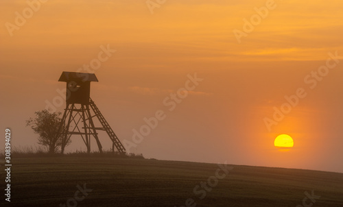 Hunting tower at dawn in the morning mist