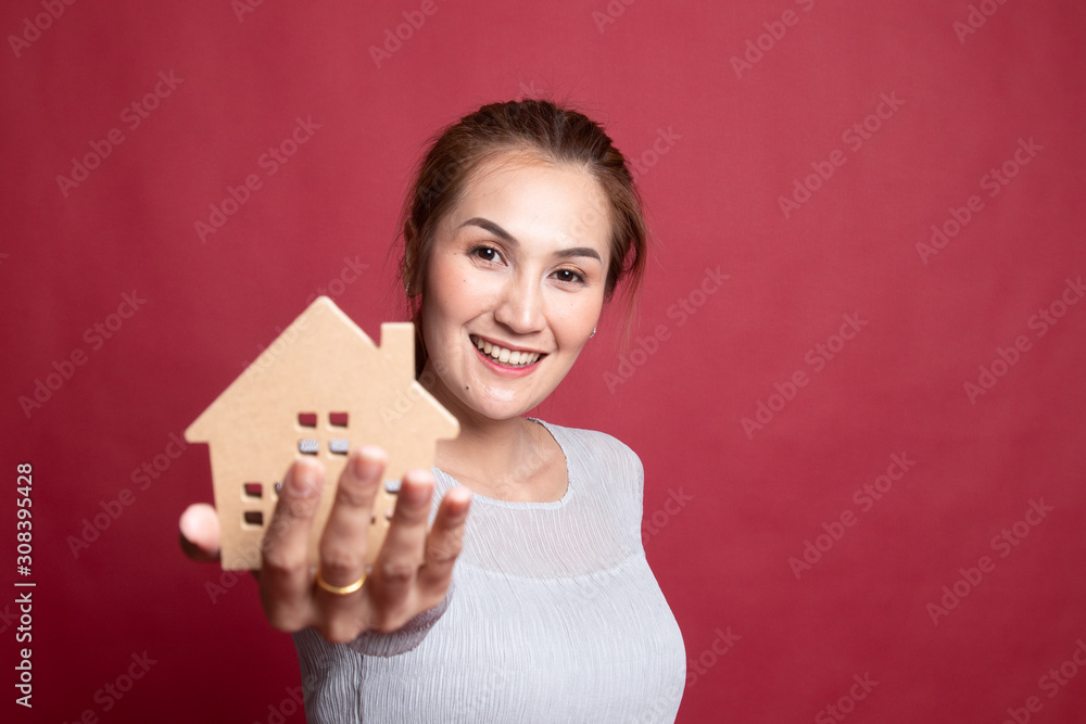 Happy young asian woman with house model. Happy young asian woman with house model.