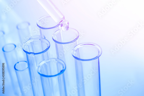 Science laboratory test blue tubes, macro flask equipment. Chemical dropper