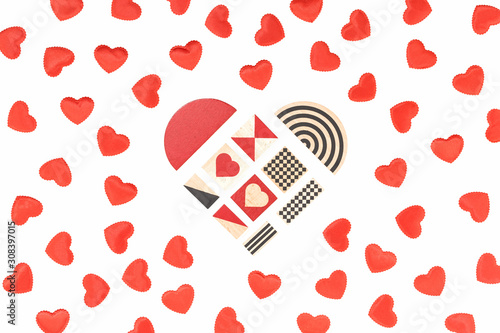 Small red fabric hearts monochrome isolated on white and a heart of graphic cubes in the middle. Passion, love and feelings St Valentine's Day Card celebration concept with copy space photo