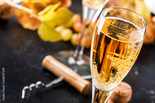 Fotótapéta Champagne, brut or sparkling wine in glass on gray background