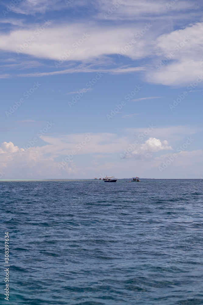 Blue ocean with ships cruising in Semporna, Borneo, Sabah.